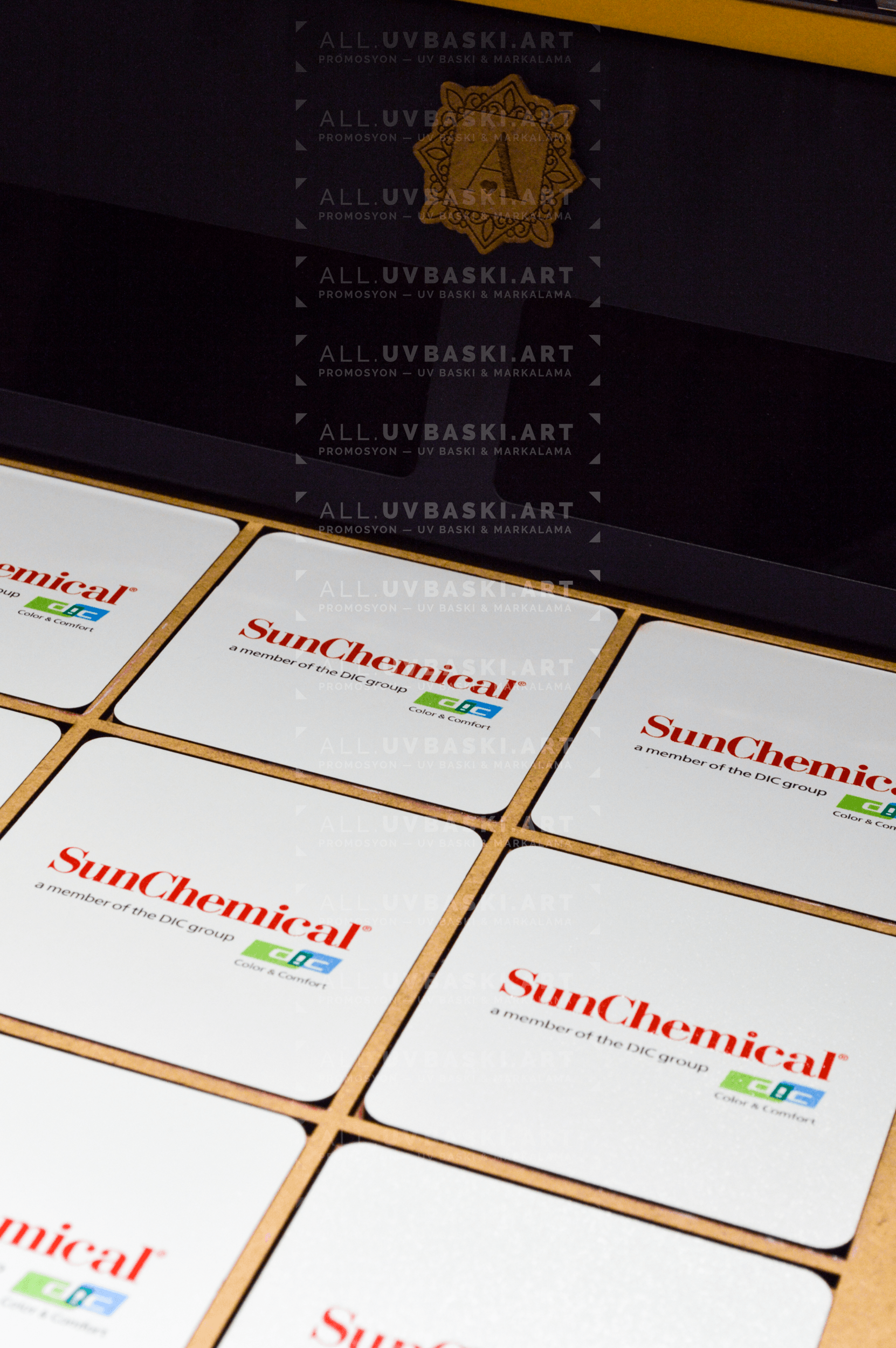 Sun Chemical logosu UV baskılı beyaz MDF coaster yakın çekim baskı detayı.